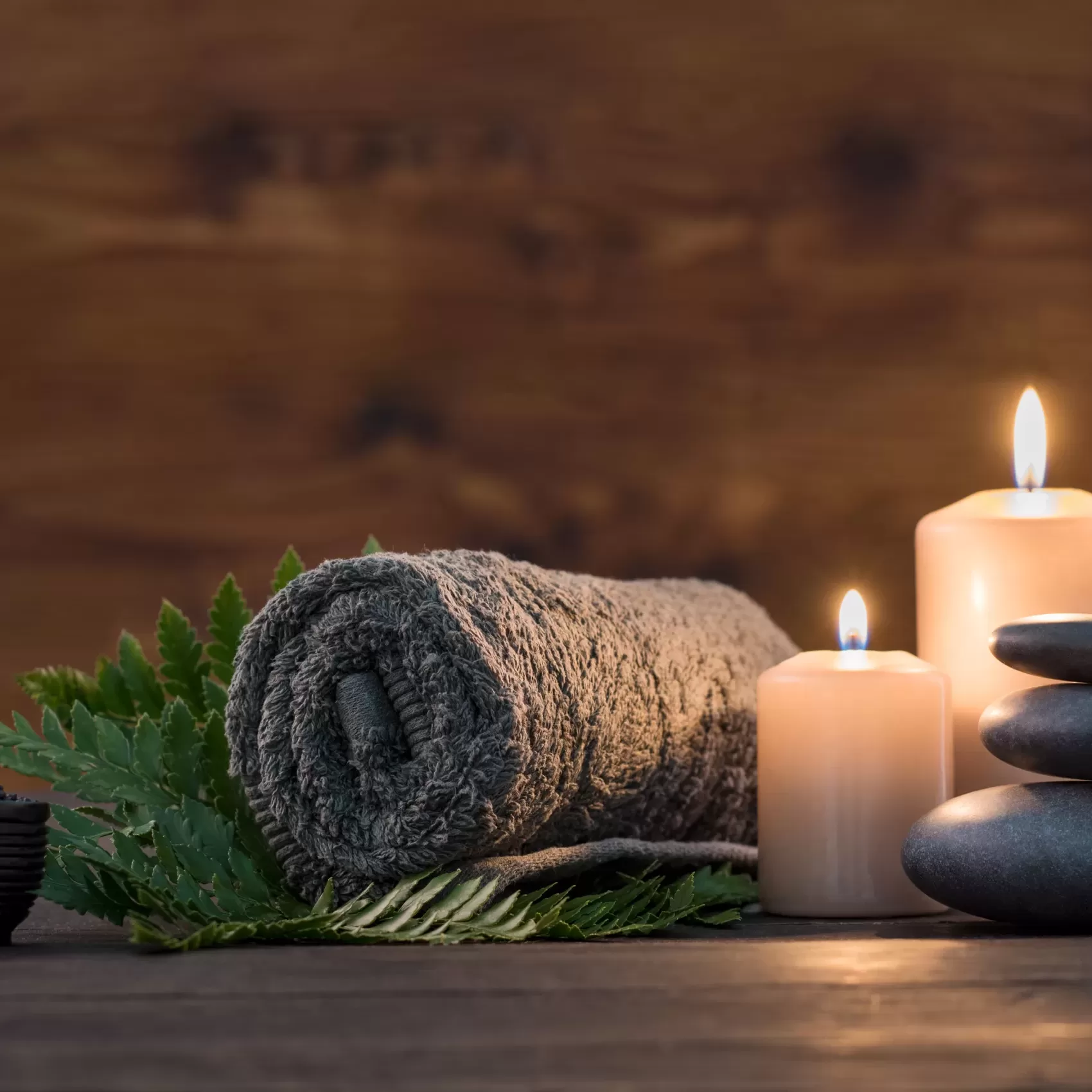 Towel,On,Fern,With,Candles,And,Black,Hot,Stone,On Towel,On,Fern,With,Candles,And,Black,Hot,Stone,On