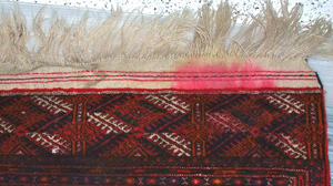 Stained rug before being cleaned by Peacock Rug Care - Treating stains on Oriental and Persian rugs