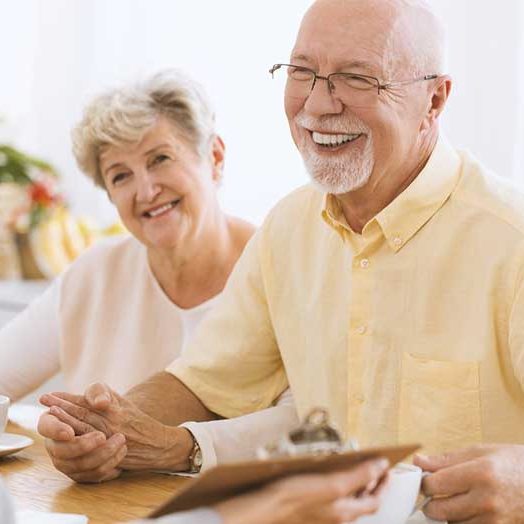 Home Improvement Options smiling senior couple with home improvement rep