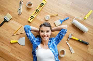 Home Improvement Products woman lying on floor next to home improvement tools